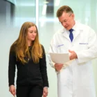 Joy, a Nurse Practitioner, reviews a scan with renowned spine surgeon, Dr. Michael Kaiser