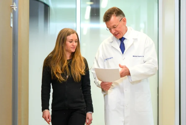 Joy, a Nurse Practitioner, reviews a scan with renowned spine surgeon, Dr. Michael Kaiser