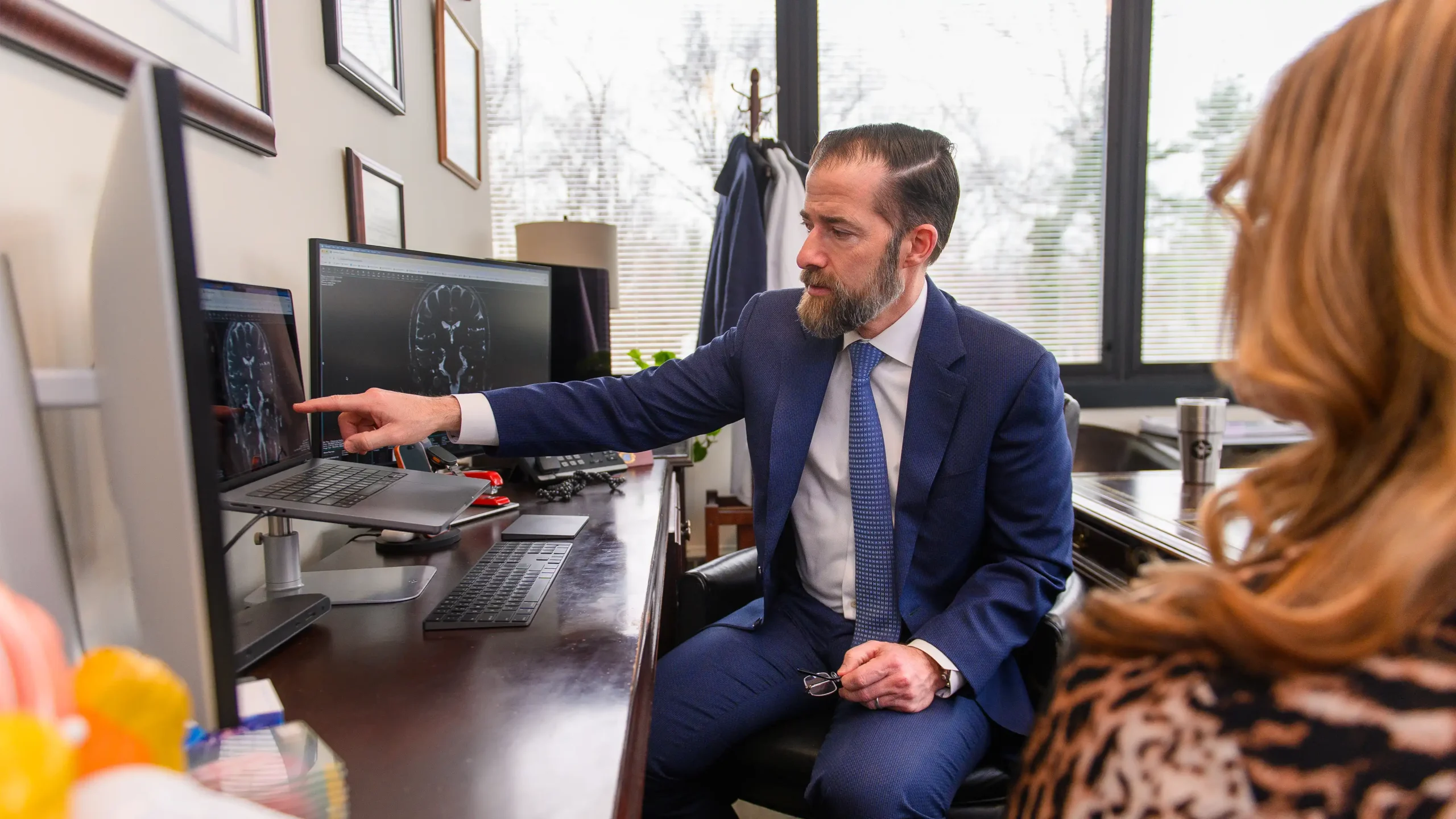 Top Hemifacial Spasm Expert Anthony D'Ambrosio sits with a patient who is presenting with symptoms of Hemifacial spasm and reviews their scans.