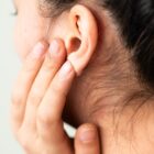 Young woman suffering from pain
