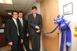 Co-Directors Dr. Ty Olson (cutting the ribbon) and Dr. Sang Sim (left) with Chief Operating Officer Bill Arnold (center) at the Gamma Knife Center Opening