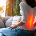 Lumbar intervertebral spine hernia, woman with back pain at home.