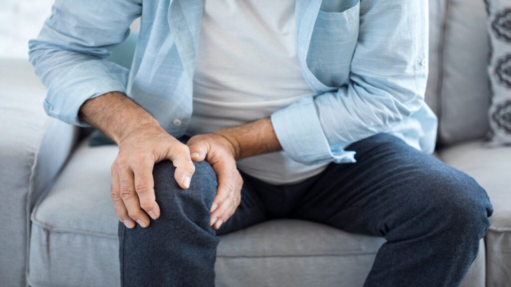Man holding his leg in pain.