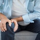 Man holding his leg in pain.