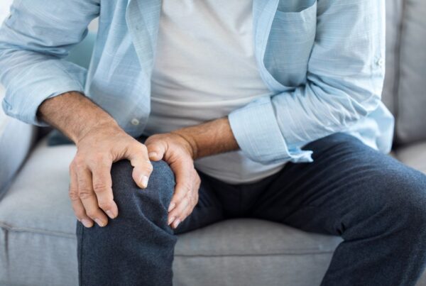 Man holding his leg in pain.