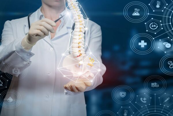 Doctor shows a human spine on blue background.