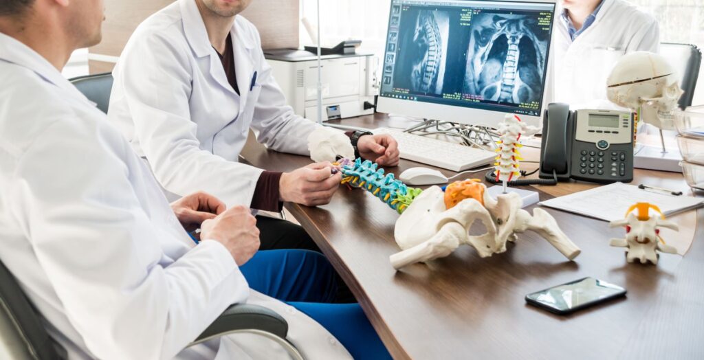 Neurosurgeons talking about spinal fusion.